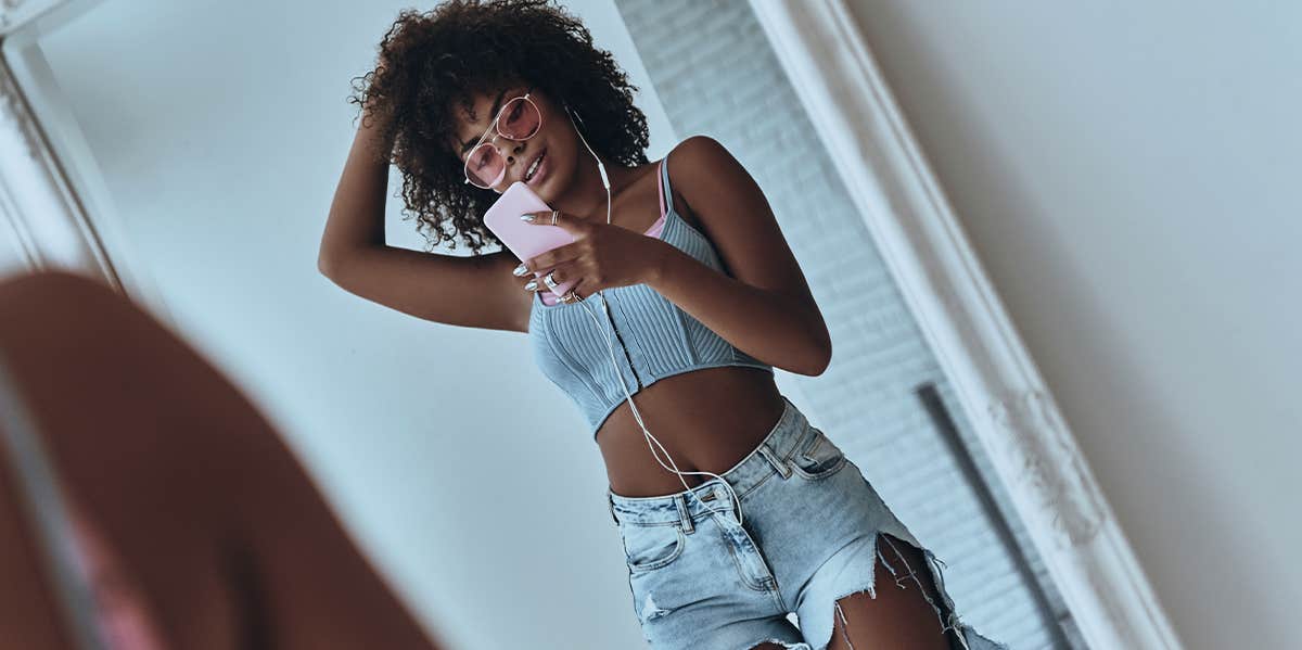 woman taking mirror selfie with phone