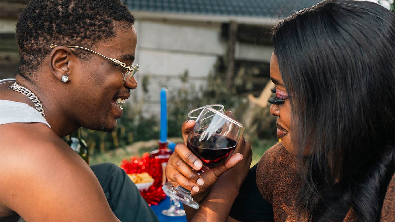 man and woman sharing drinks