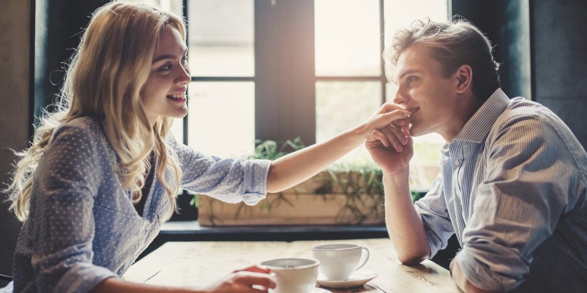 6 Subtle (But Scary) Signs He's Manipulating The Heck Out Of You man kissing woman's hand