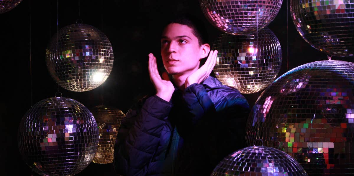man surrounded by disco ball