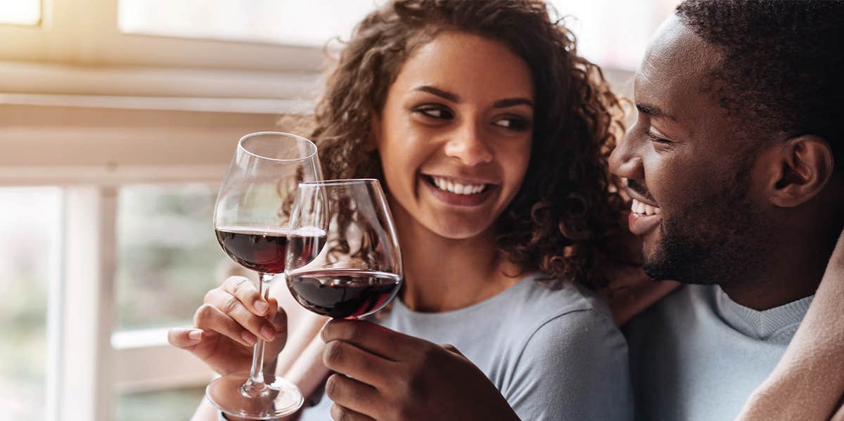 Unsexy Things People Do And Don't Do When They're In Love happy couple drinking wine