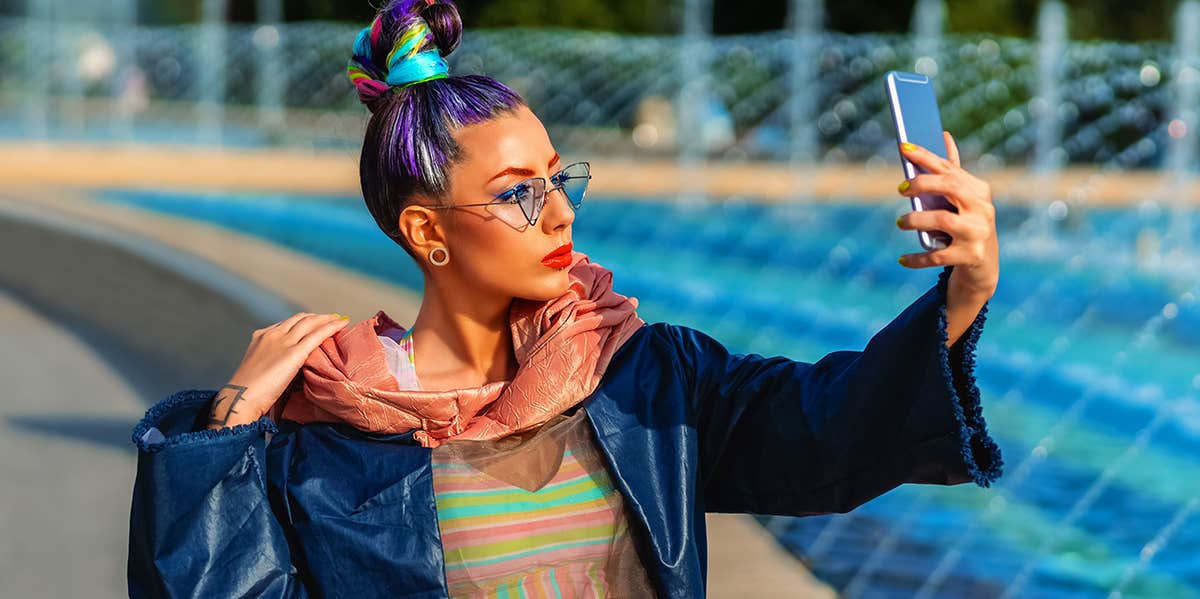 Sneaky Ways Your Selfie Obsession Is Destroying Your Health woman taking selfie