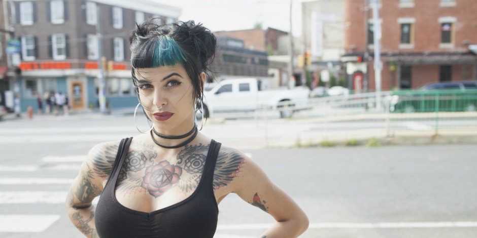 Why Woman's Gym Said Her Tank Top Made People Uncomfortable woman in low-cut tanktop and blue hair