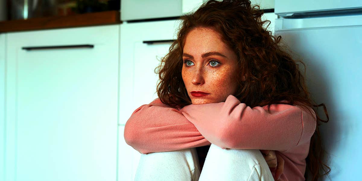 woman sitting in kitchen alone