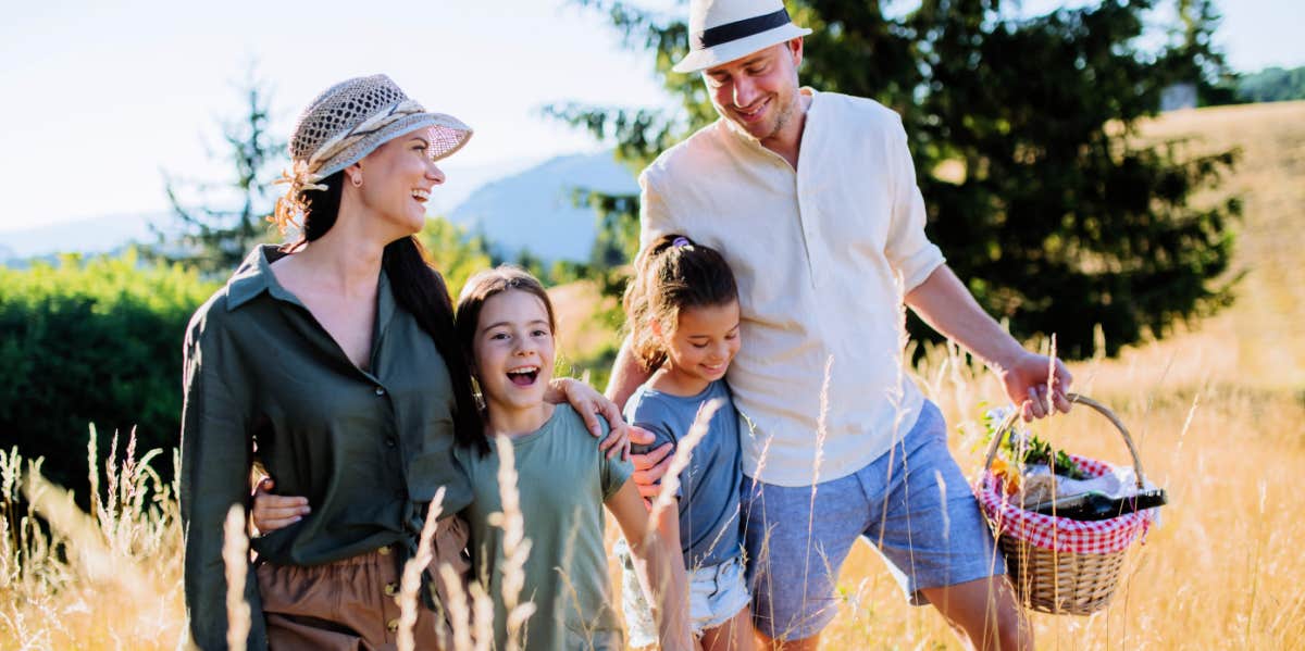 active family parents and children walking together for picnic