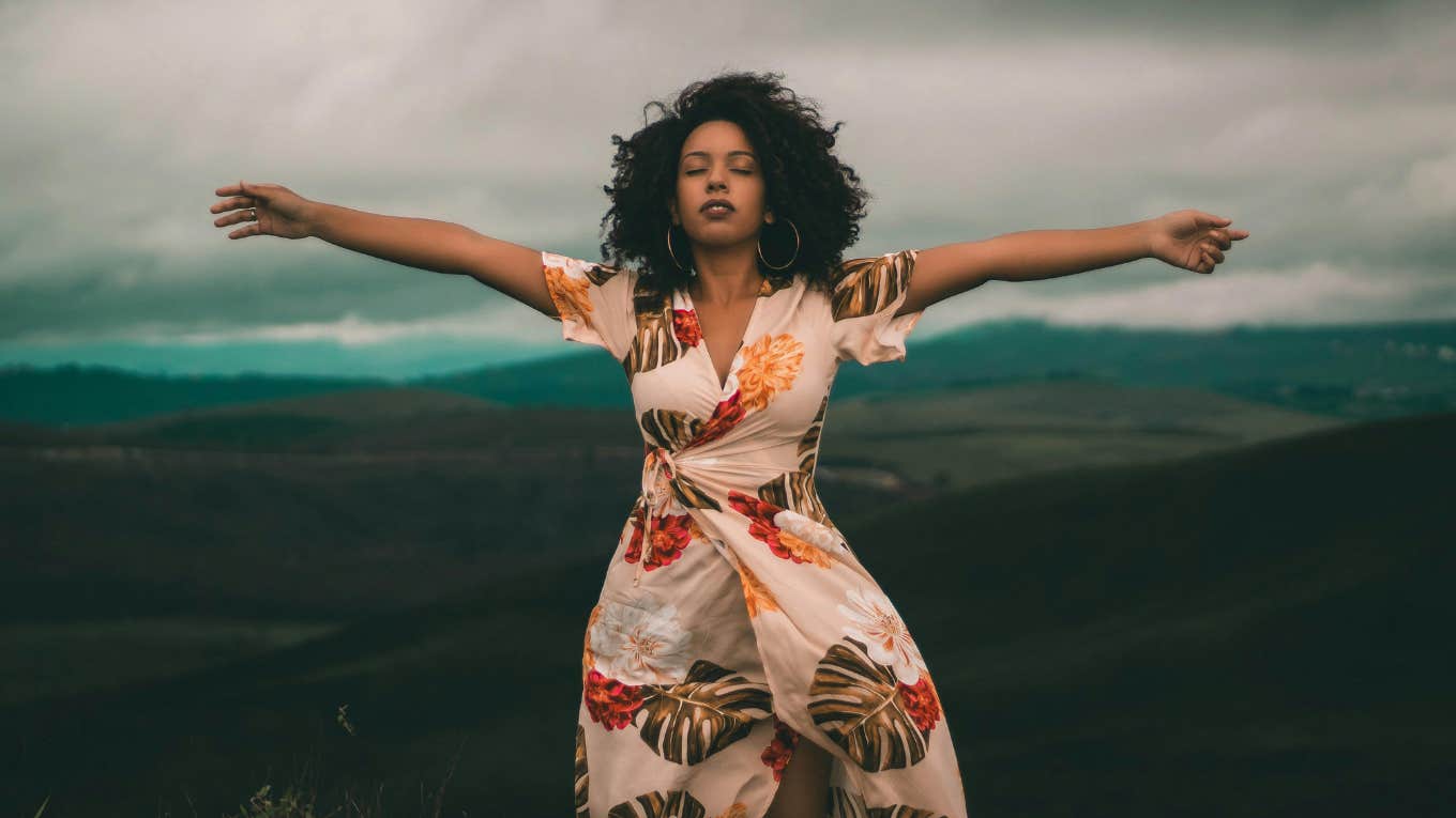 7 Phrases To Say To Your Inner Child Each Day To Overcome Your Difficult Childhood woman standing with her arms open