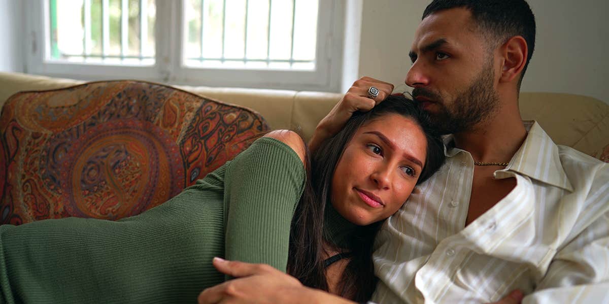 7 Brutally Honest Reasons You're Not Going All-In In Your Relationship girl laying on guy's lap