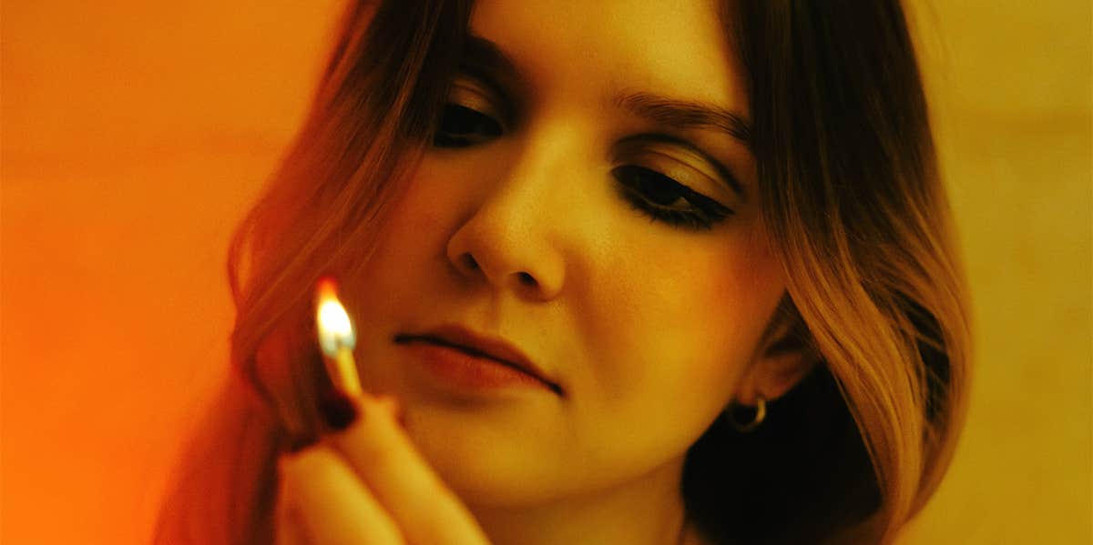 Unhealthy Signs The Person You Love Has A Martyr Complex woman holding flame