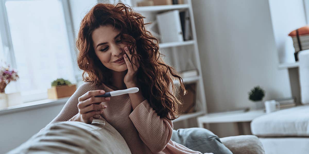 woman looking at pregnancy test