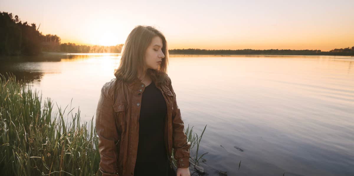 sad woman by a lake