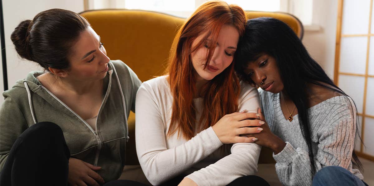 two women comforting sad friend