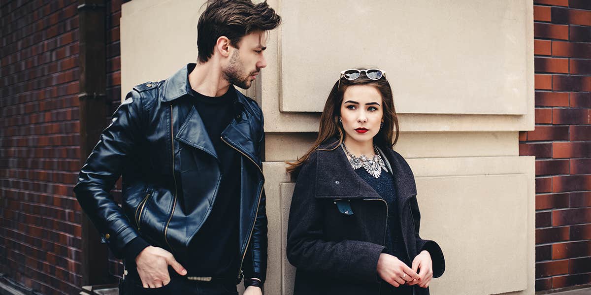 Subtle Signs You're On A Date With A Total D-Bag man and woman standing outside wearing leather jackets