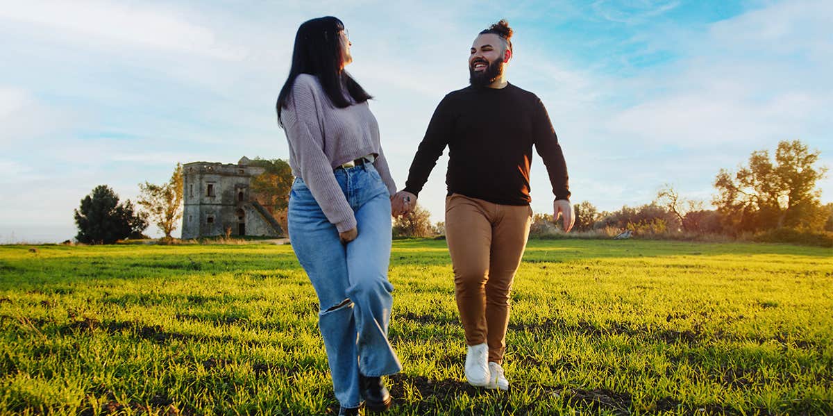 Things Women Obsess About That Don't Matter To Men couple holding hands walking in green field