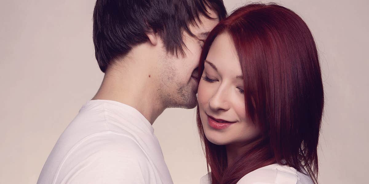 7 Phrases You Should Be Telling Her Other Than 'I Love You' man whispering by the woman