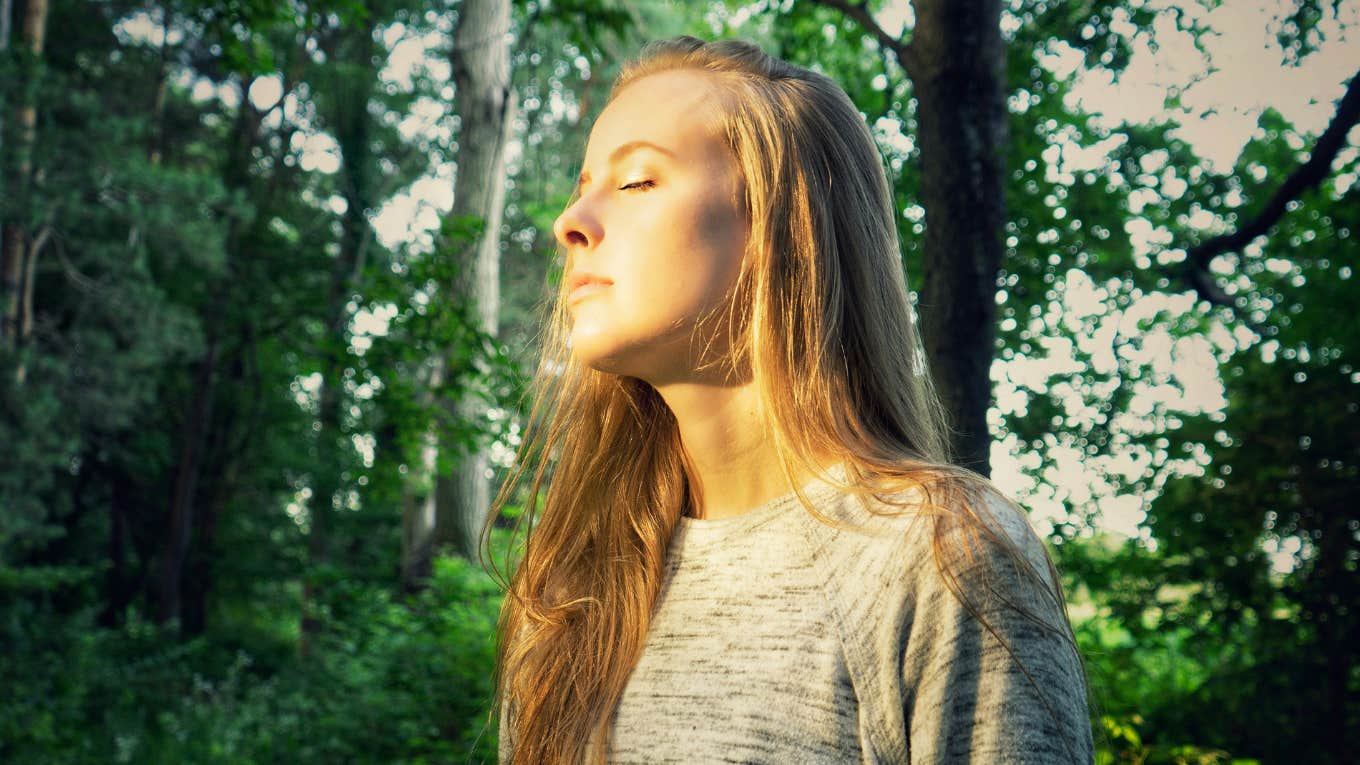 woman standing in a forest 