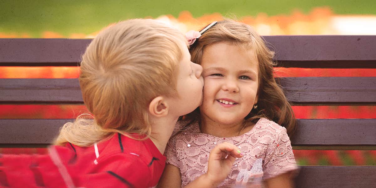 little boy kissing a little girl