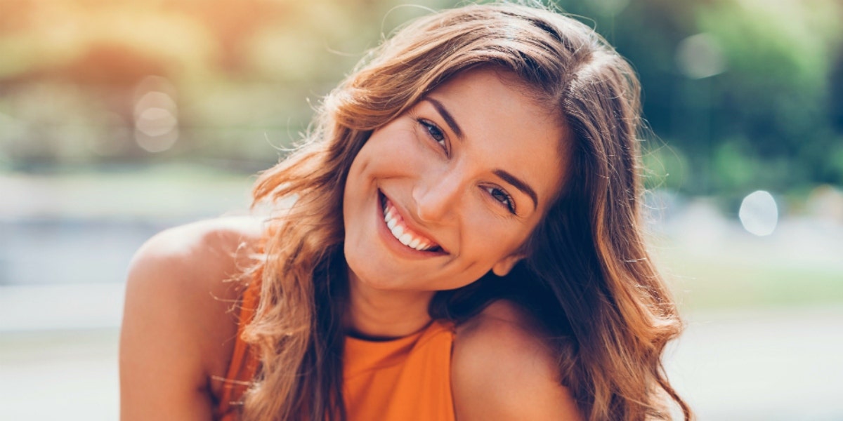 How The 7-Year Cycle Affects Your Mind & Body Every 7 Years woman smiling and tilting her head