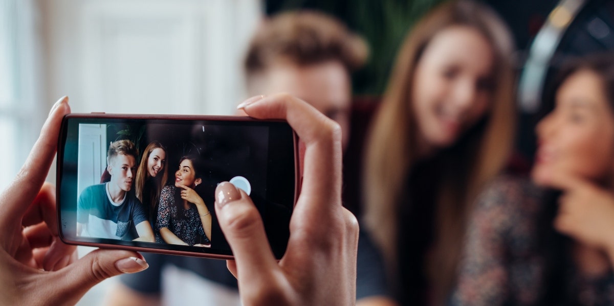 75 Baddie Instagram Captions - Short, Sassy Captions About Attitude hands taking a photo of a group of friends