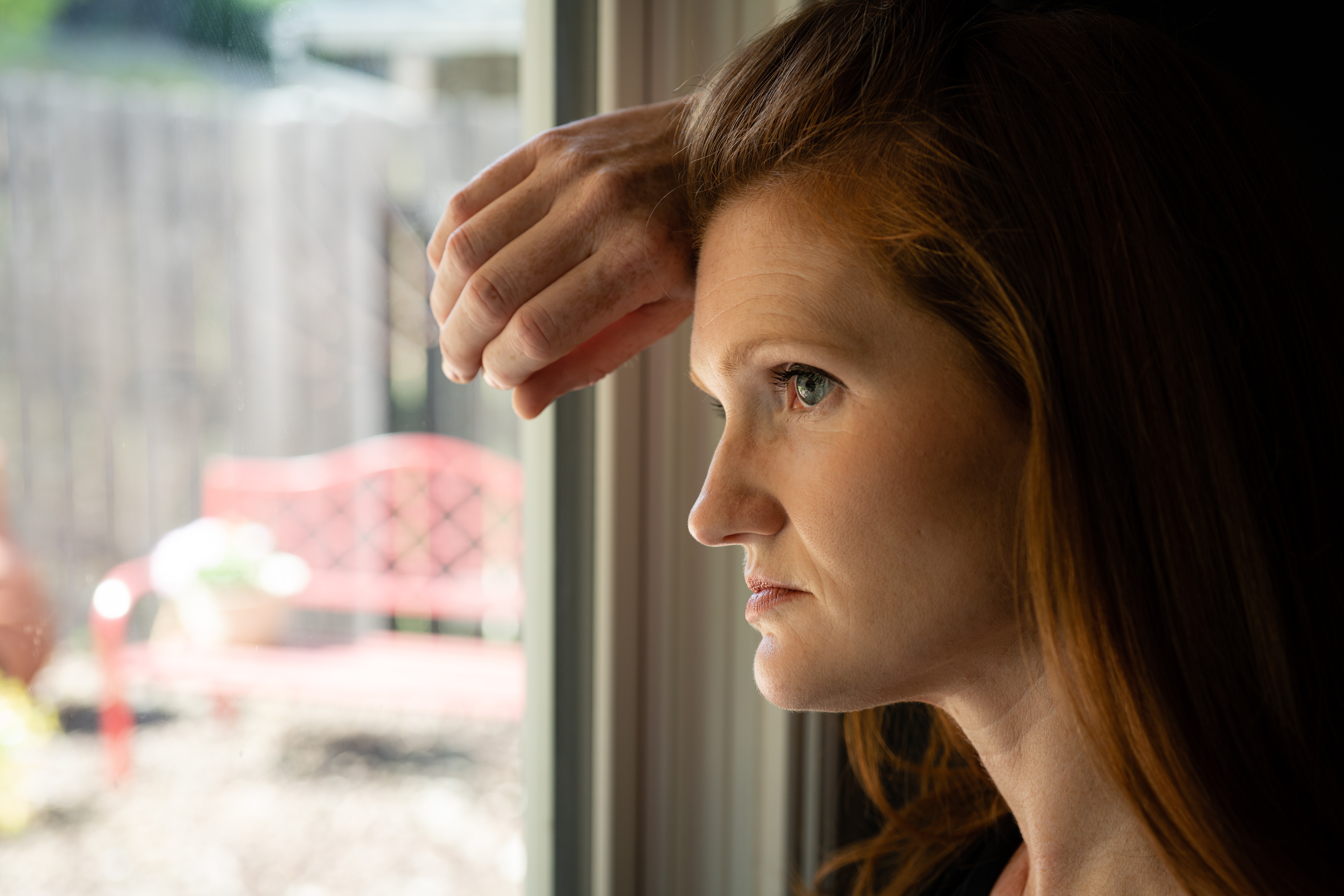 woman looking out window