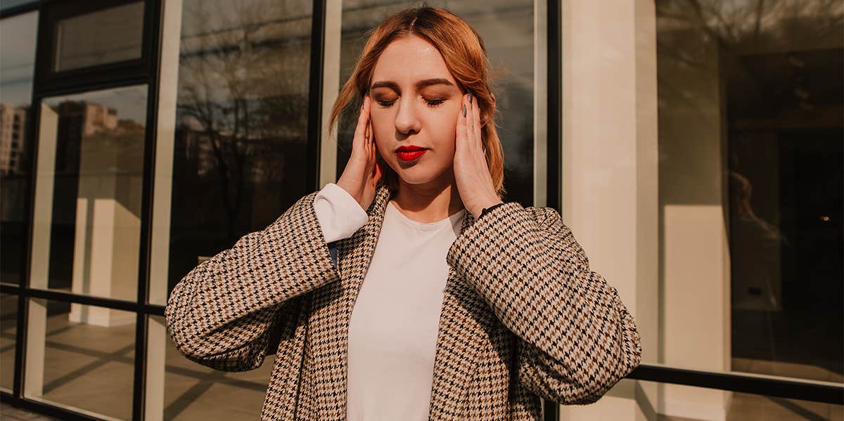 woman holding head overwhelmed