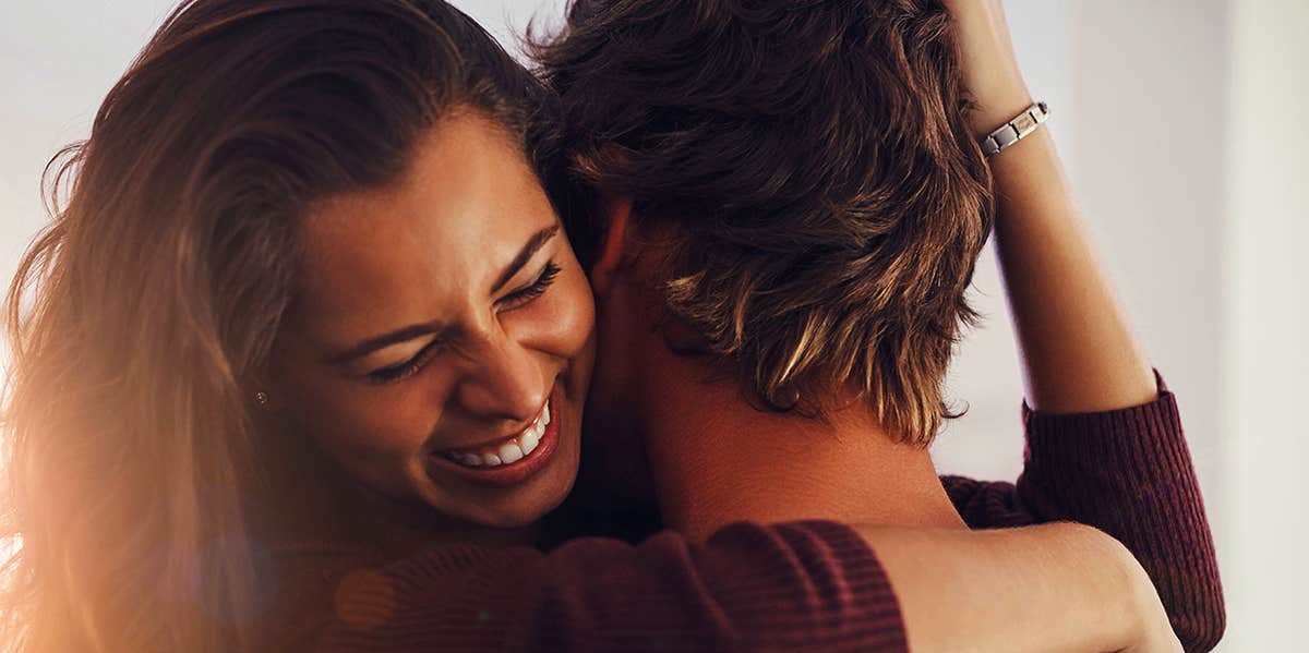 girl hugging guy while smiling