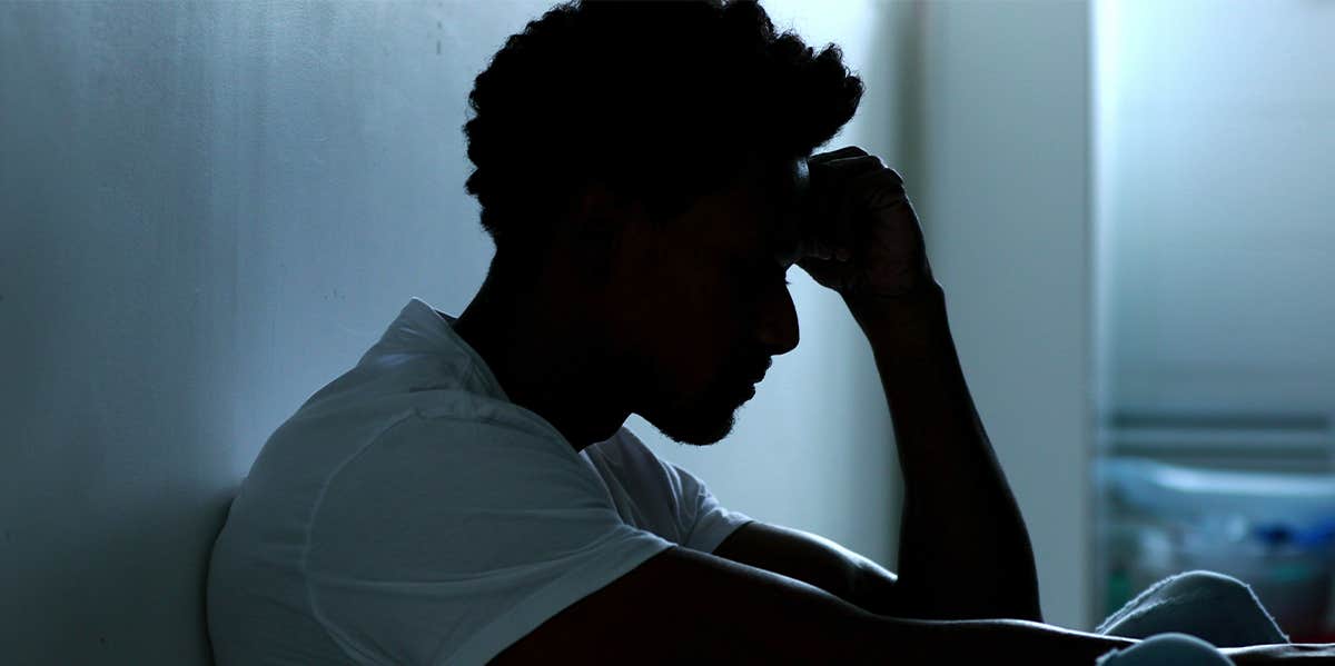 man sitting alone in the dark