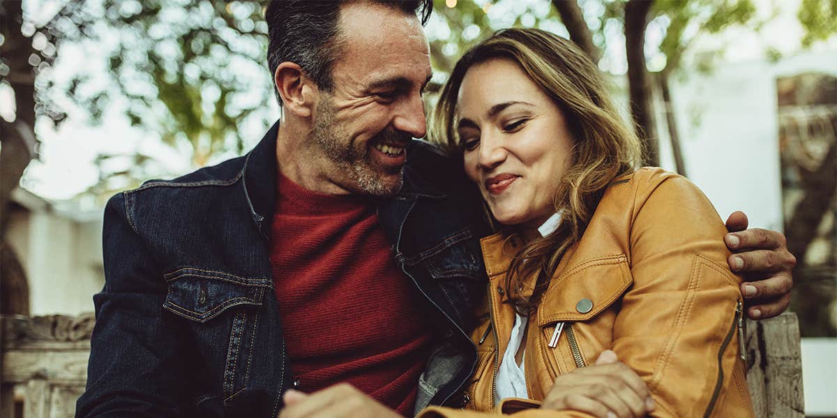 middle aged couple dating man has his hand around her