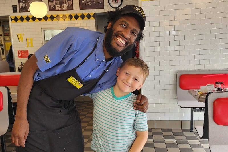 A Waffle House employee and an 8-year-old boy who started a fundraiser for him.