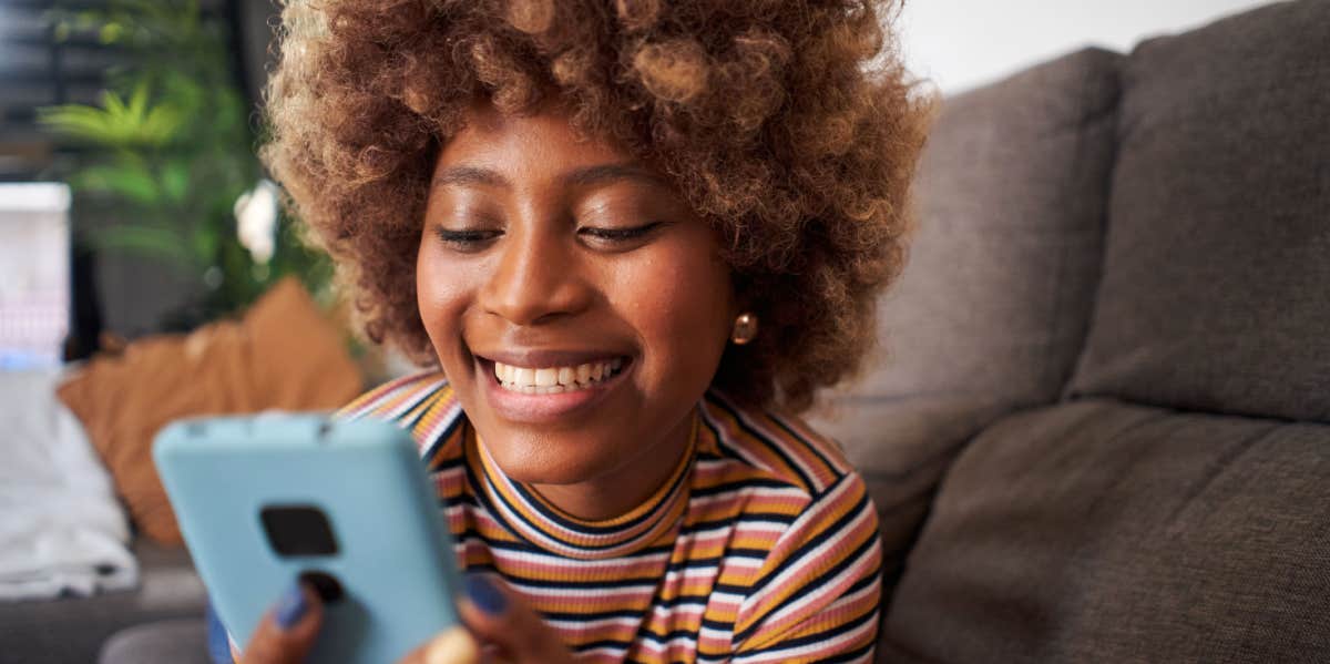 smiling girl looking at phone