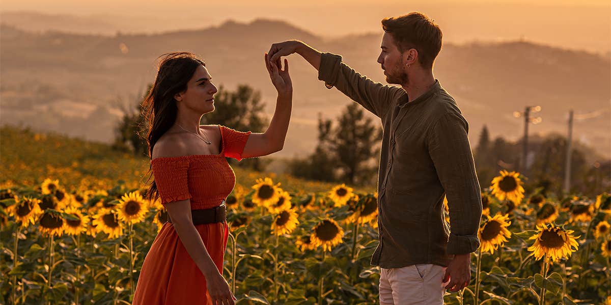 Incredible Health Benefits Of Being In Love couple dancing in sunflower field