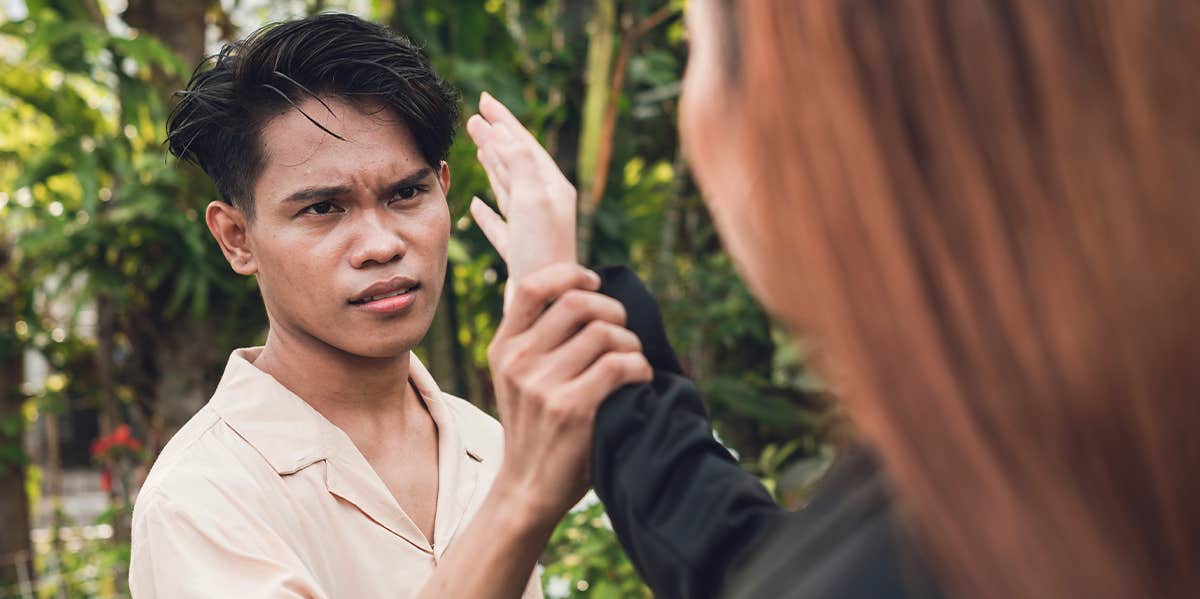 man controlling woman grabbing arm