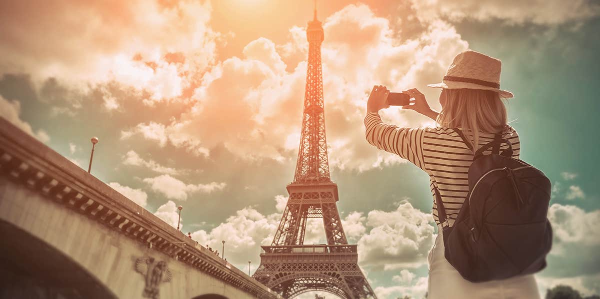 Woman taking photo of Eiffel Tower