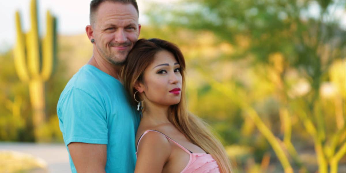 two contestants from 90 day Fiancé stand in a desert setting