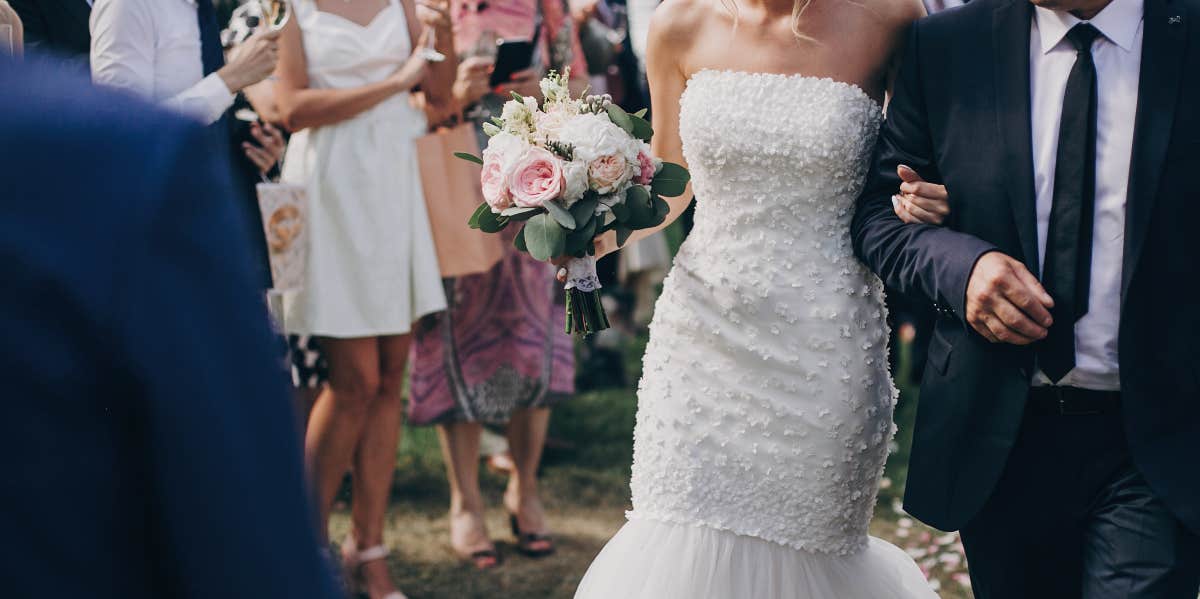 A father walks the bride down the aisle at a beautiful wedding