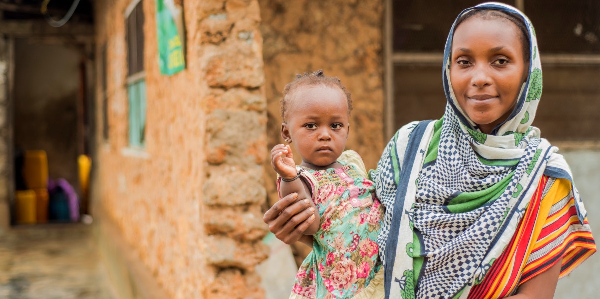 Why Straight Women Are Marrying Each Other In Tanzania woman holding baby