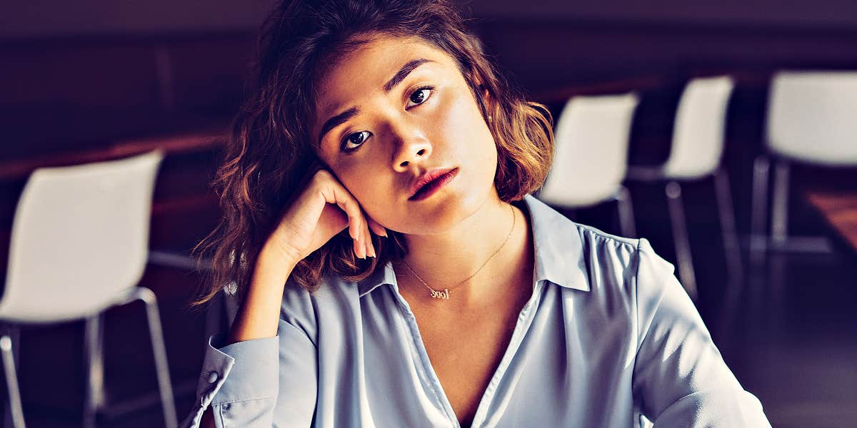 young Asian woman looking serious is a cafe