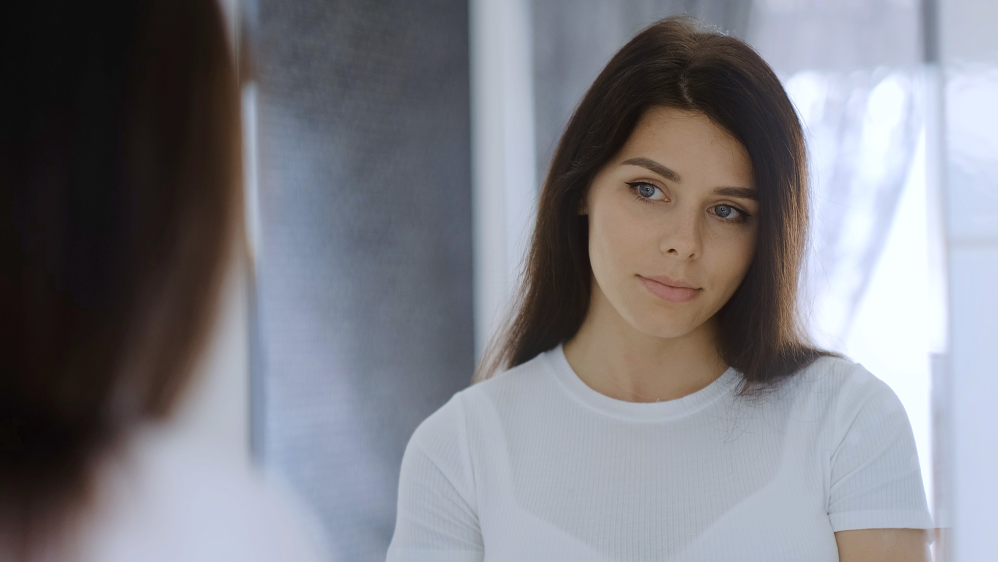 woman looking in mirror