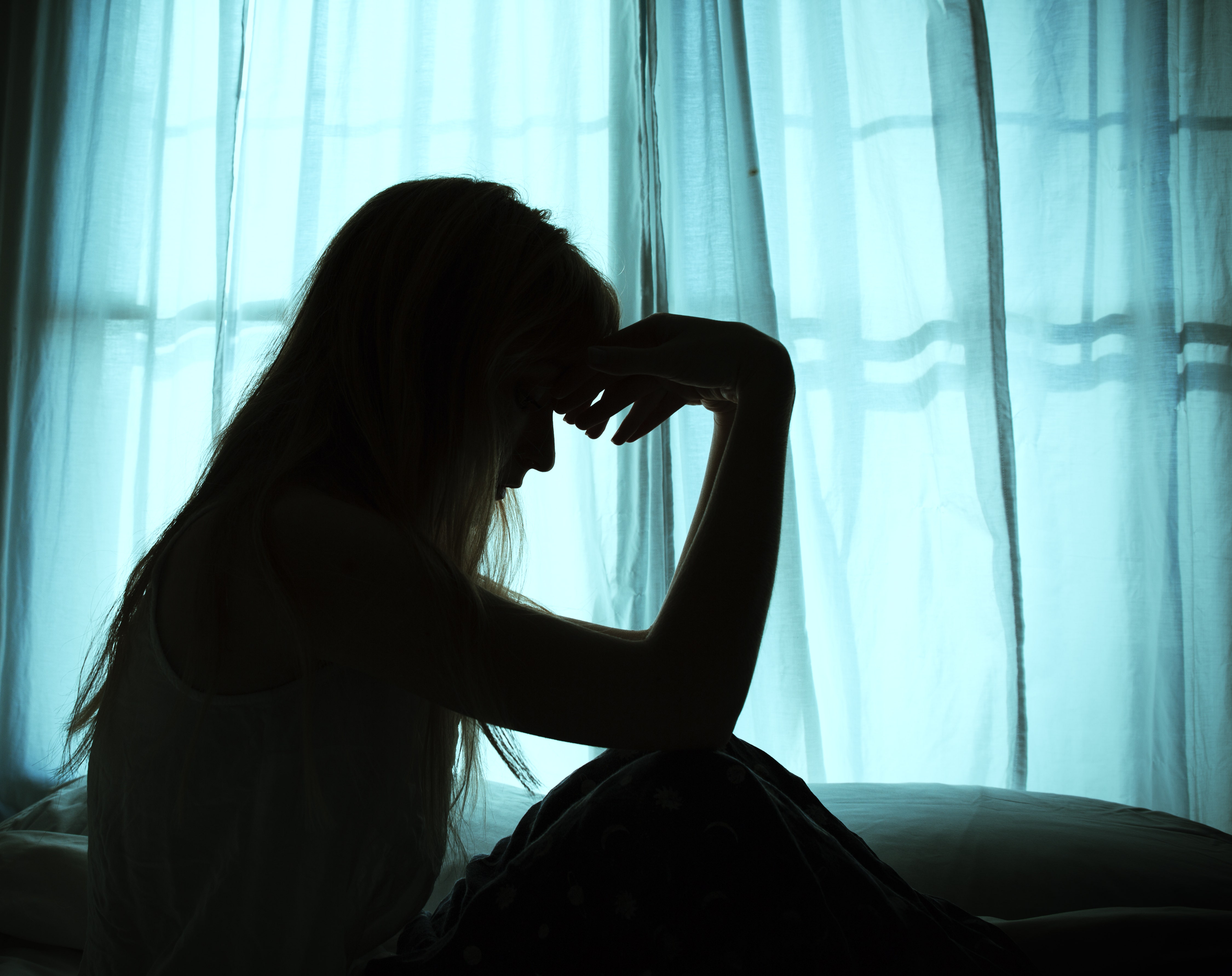 grieving woman in shadow