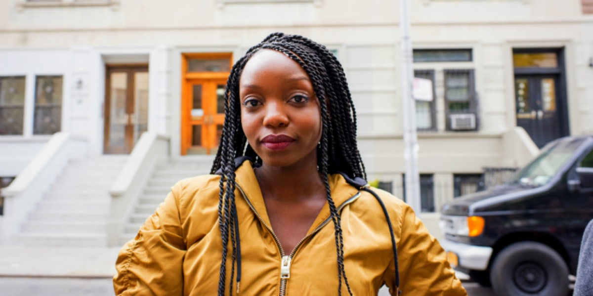 woman in yellow zip jacket looking forward