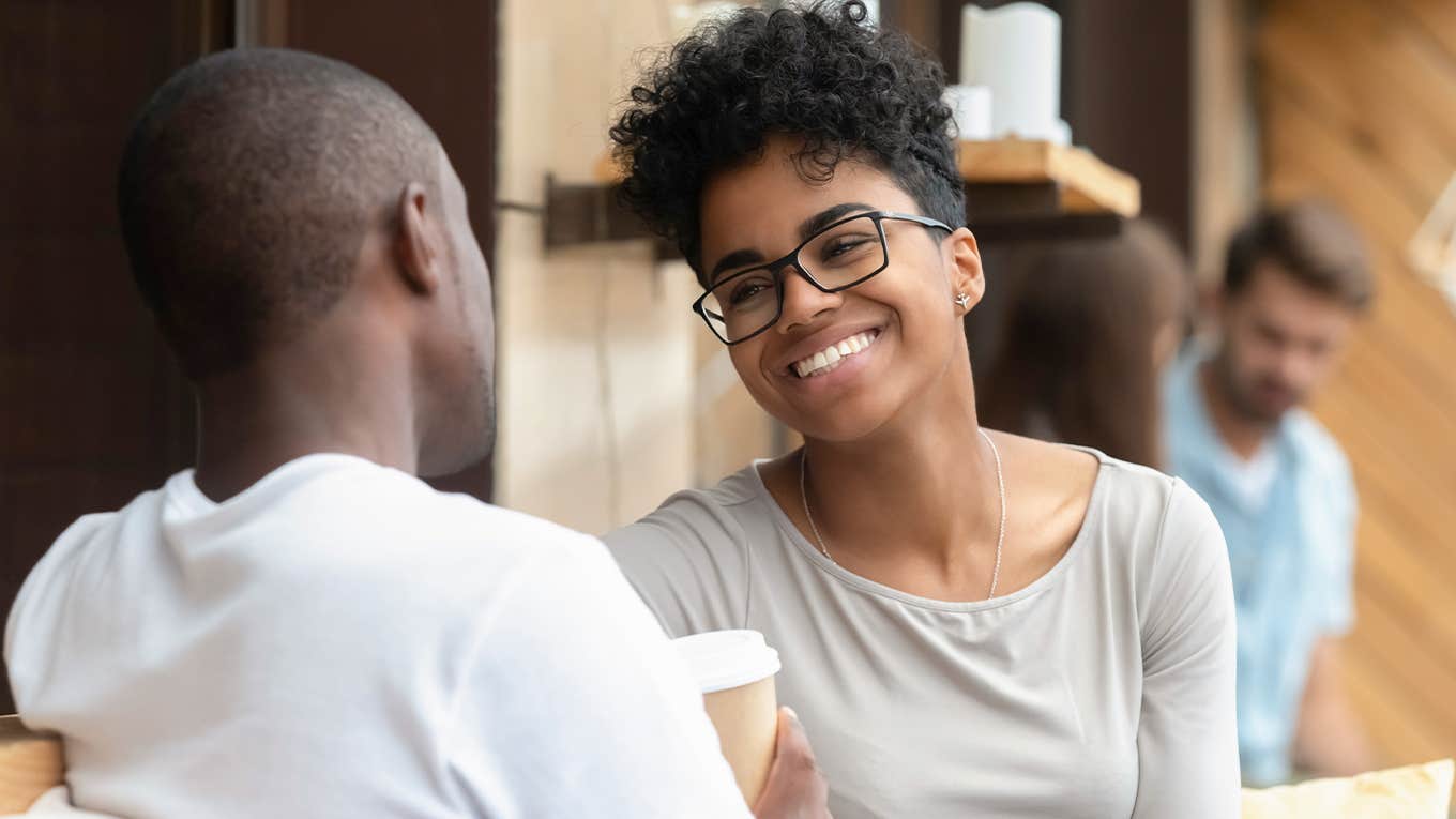 Happy young women smiling at man 