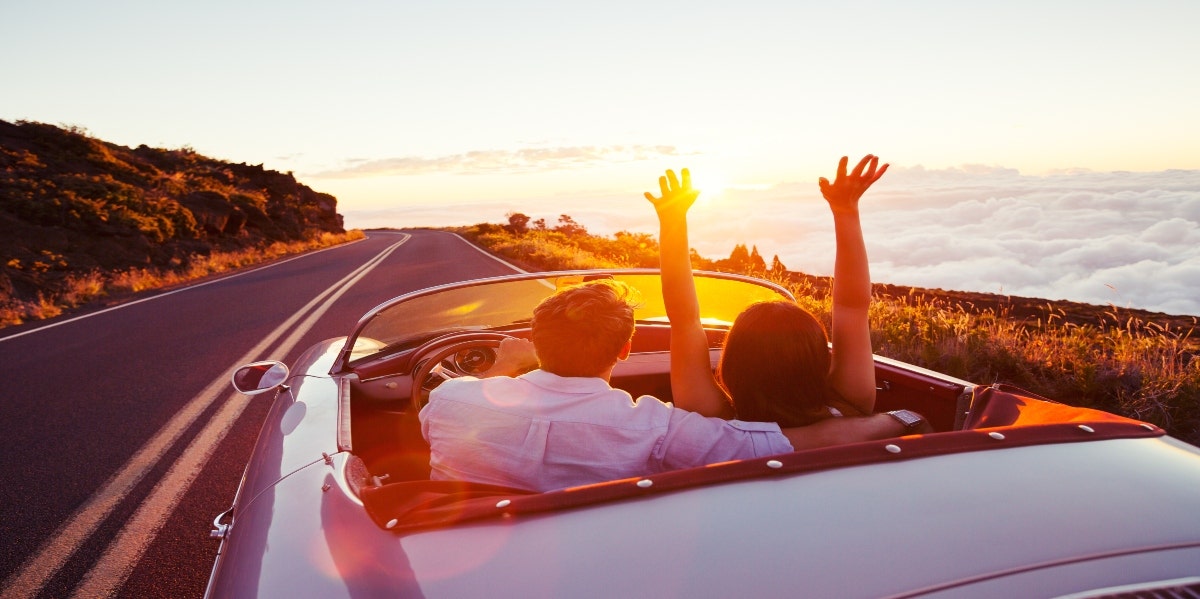 Couple driving on sunny road