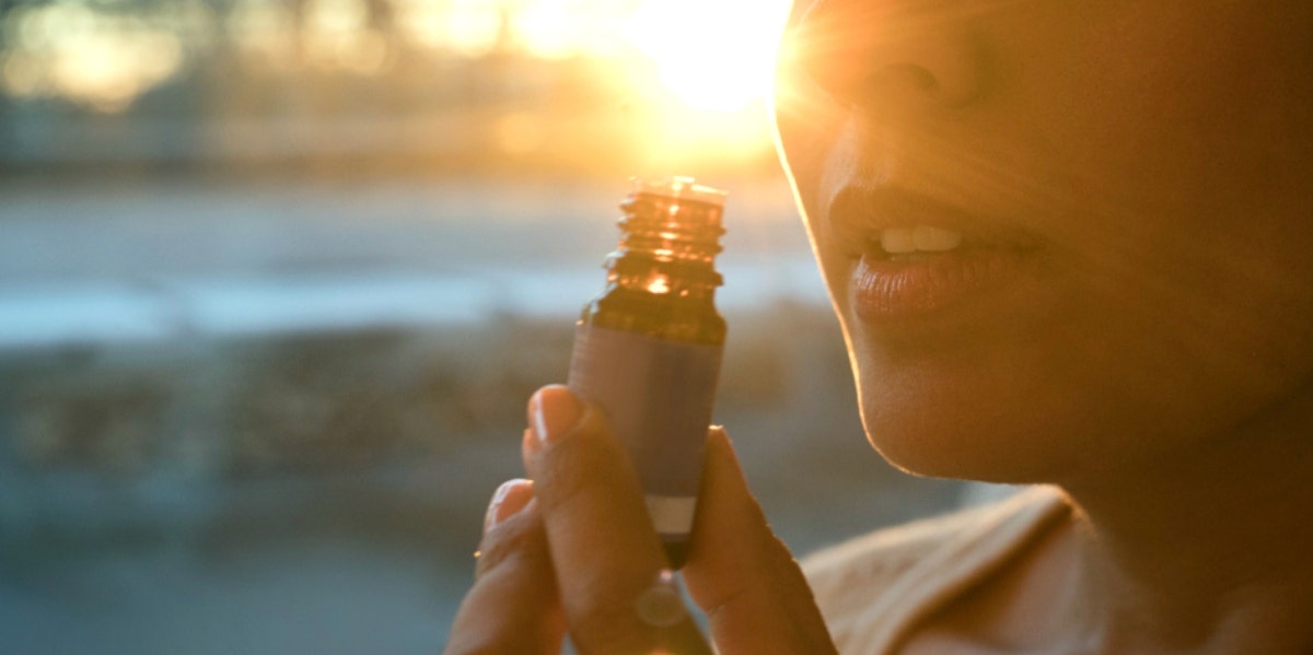 woman smelling essential oil