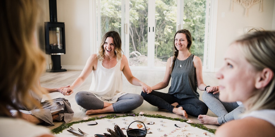 women in circle holding hands