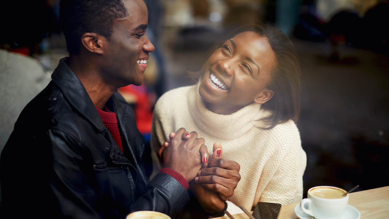 Laughing young couple in cafe