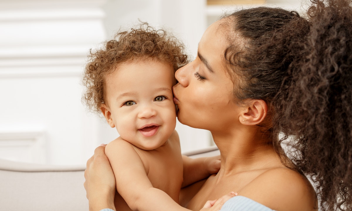 mom kissing her baby