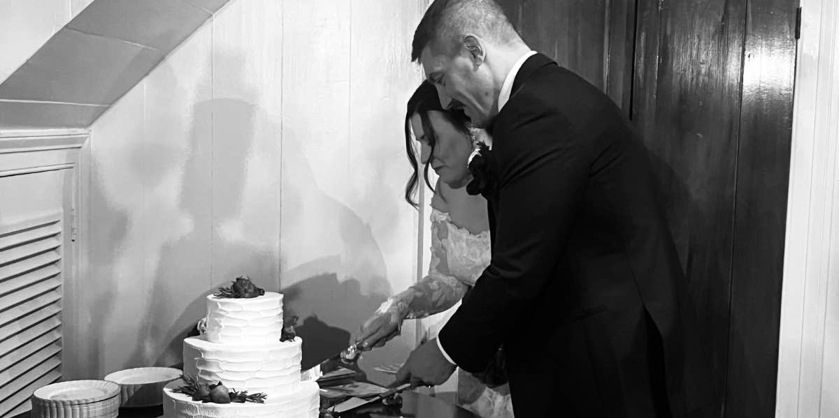 Couple cutting wedding cake 