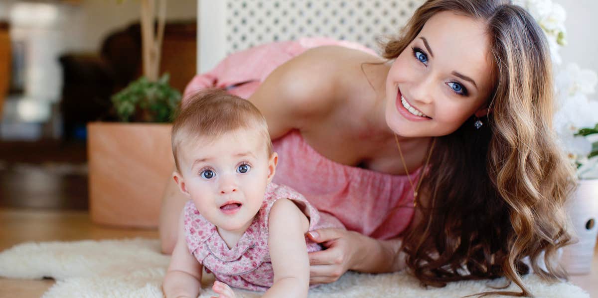 mom with baby on rug