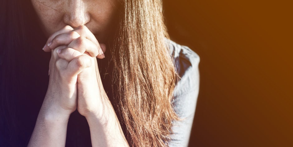 Distraught woman praying Distraught woman praying