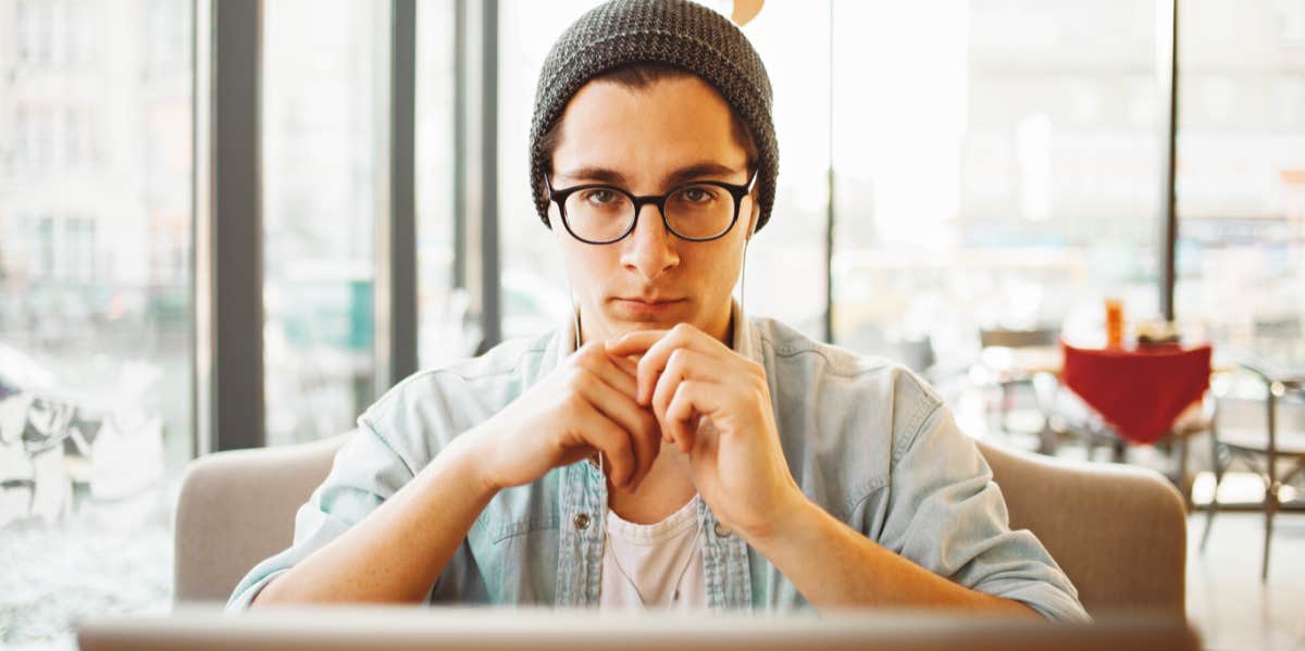 white man in glasses looks at the screen, giving silent treatment