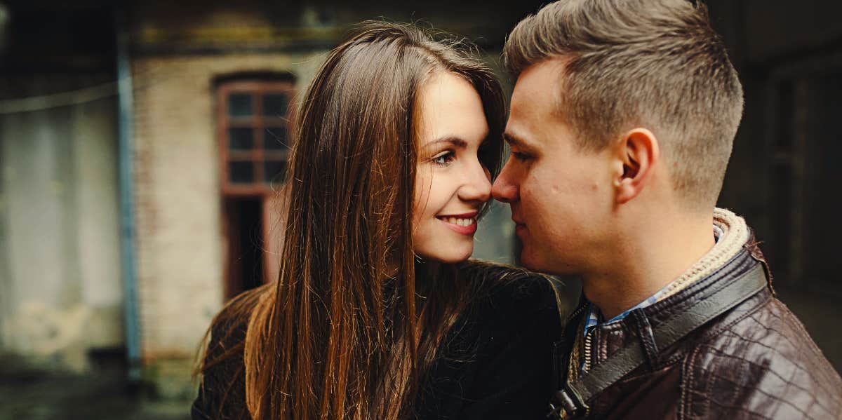 Young woman gazes at young man.